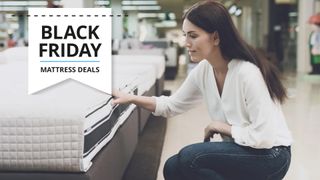 A woman touching a mattress in a store