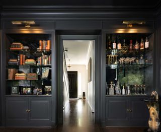 a dark home bar looking onto an entryway