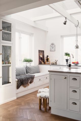White Scandinavian kitchen with wood floor and white walls