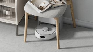 SwitchBot K10+ Pro robot vacuum under chair