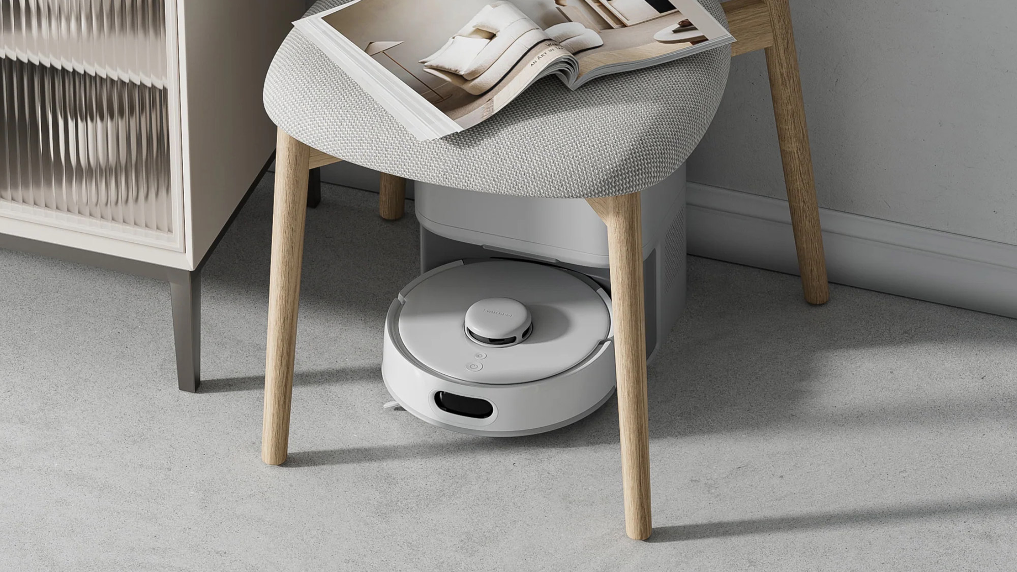 SwitchBot K10+ Pro robot vacuum under chair