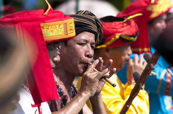 A performer on the flute in Wuzhishan prior to the presentations.