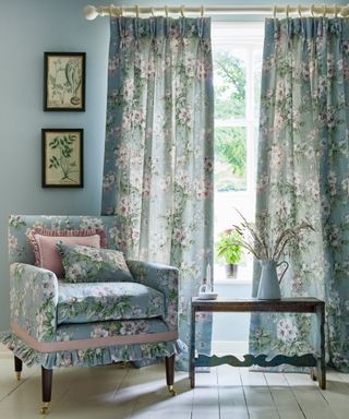 Armchair in blue with matching curtains and blue walls