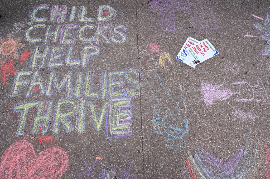 Sidewalk chalk drawings done by parents and children to celebrate Child Tax Credit payments in Brooklyn, New York. Photo by Bryan Bedder/Getty Images for ParentsTogether.