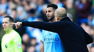 Pep Guardiola gives Riyad Mahrez instructions in Manchester City's Premier League game against Leicester in April 2023.