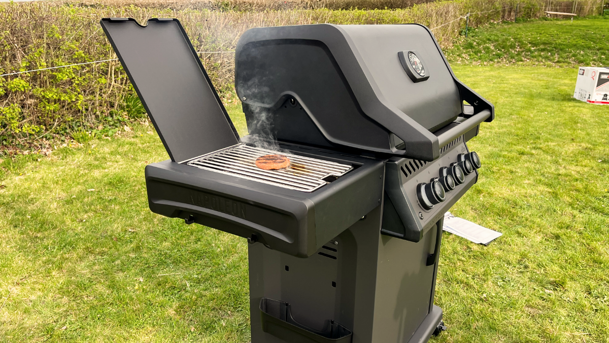 burger grilling on the side burner of the Napoleon Phantom Rogue SE 425 RSIB