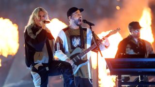 Linkin Park on stage, surrounded by pyro