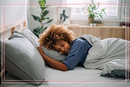 how much deep sleep do you need illustrated by woman lying on her front in bed with her eyes closed