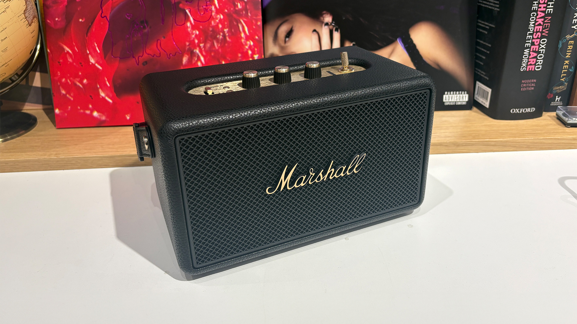 Marshall Kilburn III wireless speaker in front of busy bookcase