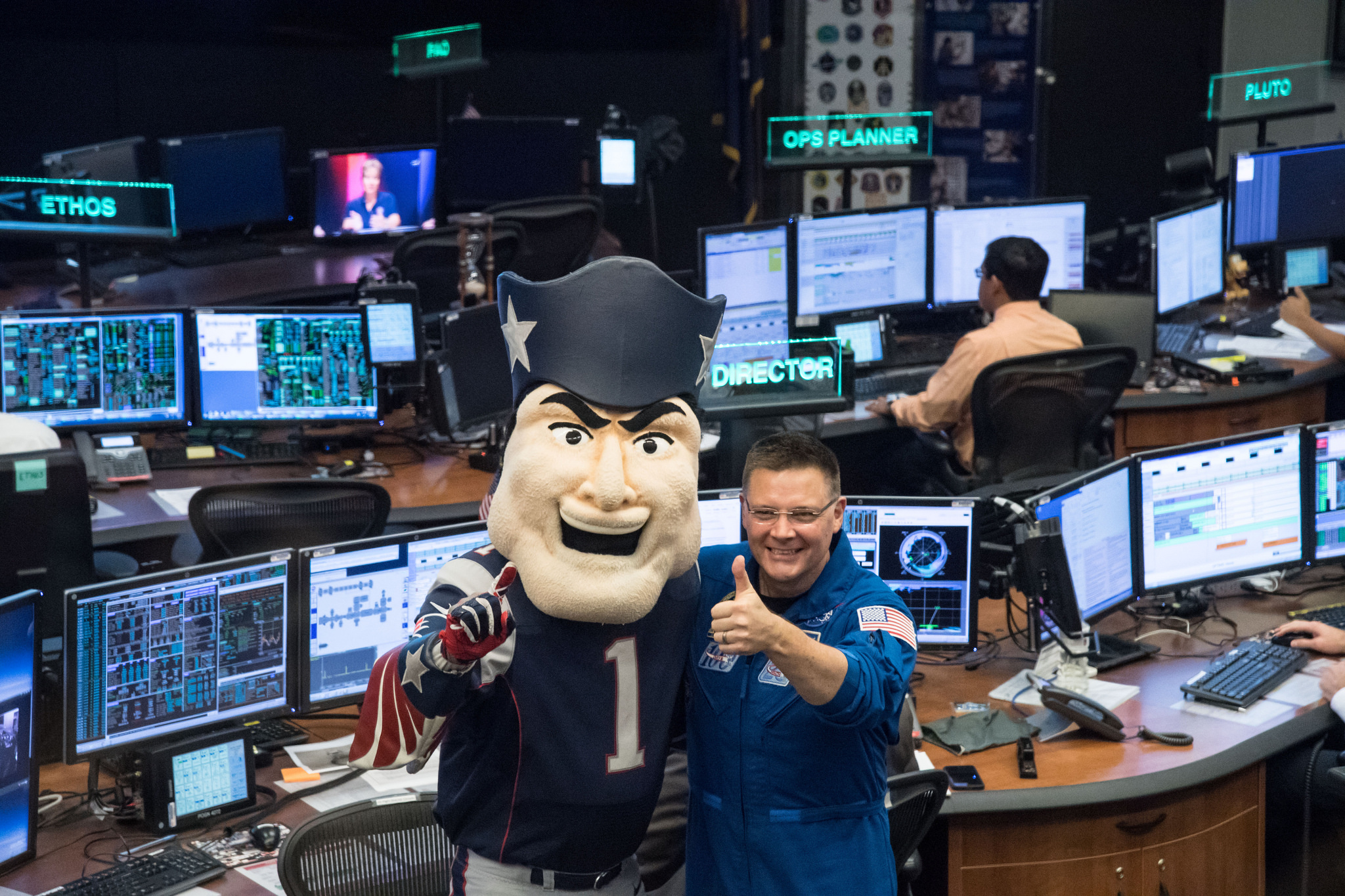 A NASA astronaut poses with Pat Patriot, mascot of the New England Patriots, during a visit to Mission Control in Houston at Johnson Space Center ahead of Super Bowl LI. The Patriots will face off against the Atlanta Falcons during the big game.