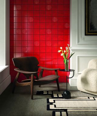 red and white living room with red tiled wall, white walls, mahogany modern chair, cream rug and armchair