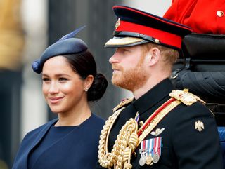 Meghan, Duchess of Sussex and Prince Harry, Duke of Sussex travel down The Mall in a horse drawn carriage during Trooping The Colour