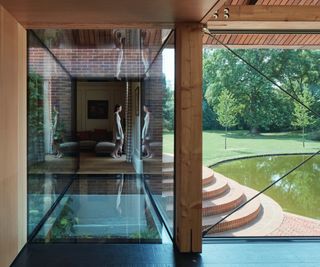 glass link extension with glass floor looking onto outdoor pool area