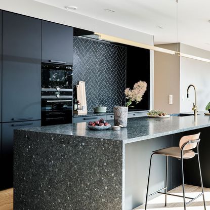 kitchen with granite worktop and dark grey cabinets