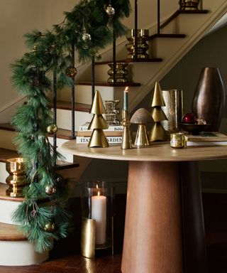 Modern Christmas entryway with gold decorations and foliage
