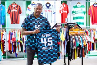 Former England defender Viv Anderson wearing and holding a limited edition Prostate United 2024 shirt inside Classic Football Shirts store in Manchester