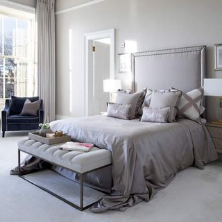 Town house bedroom with luxe upholstered grey bed