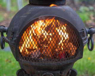 burning fire inside chiminea