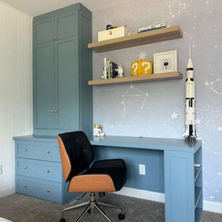 A home office desk with storage on top made with an IKEA BILLY bookcase, all painted in blue