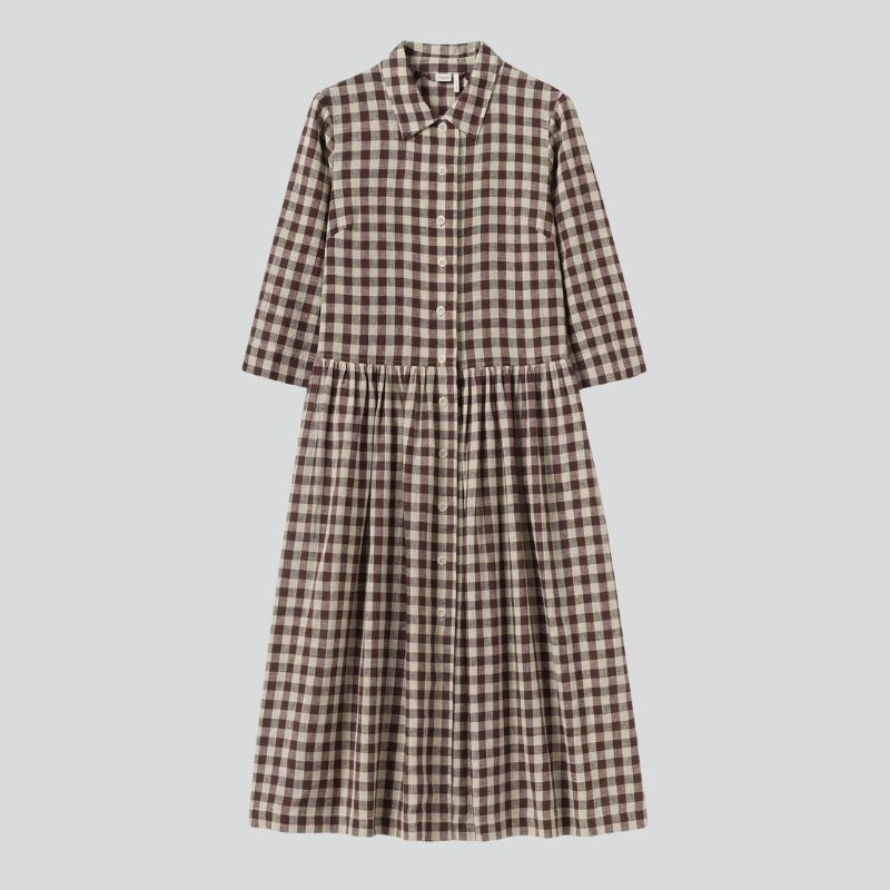 A cutout of a brown gingham dress by Toast
