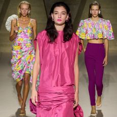 three models wearing 80s inspired clothes at fashion month