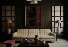 A living room with a cream sofa, and dark brown walls, along with plum stools