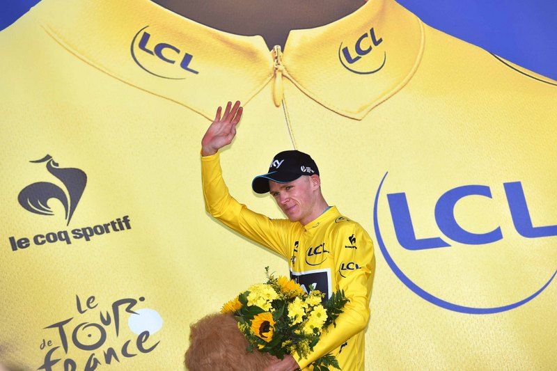 Chris Froome waves from the podium