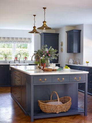 kitchen with blue island and cabinets and french windows and long glass pendant light above