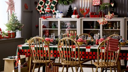 ikea christmas dining table with tablecloths, bowls, candles, napkins, wreaths, and lamps