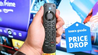 The Alexa Voice Remote Pro in hand with a Tom's Guide price drop deals badge