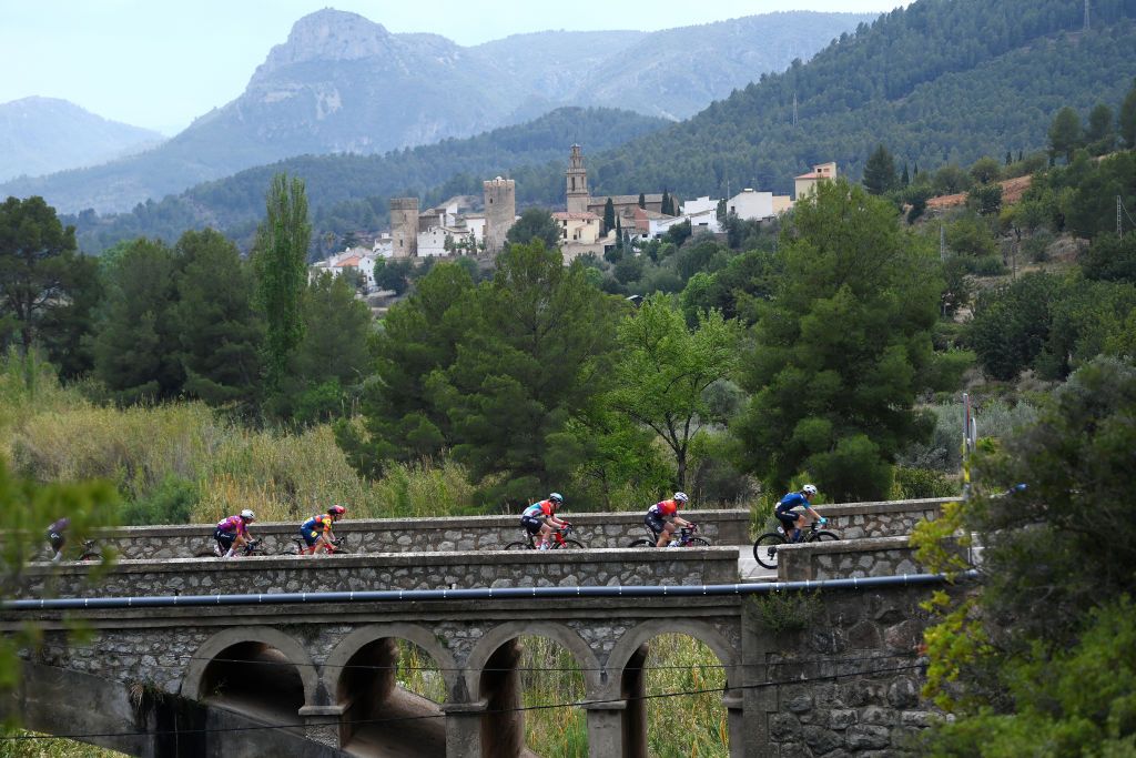TERUEL SPAIN APRIL 30 LR Barbara Guarischi of Italy and Team SD Worx Protime Elizabeth Deignan of The United Kingdom and Team Lidl Trek Fauve Bastiaenssen of Belgium and Team Lotto Dstny Ladies Romy Kasper of Germany and Team Human Powered Health and a general view of the peloton passing Argelita village during the 10th La Vuelta Femenina 2024 Stage 3 a 1303km stage from Lucena del Cid to Teruel UCIWWT on April 30 2024 in Teruel Spain Photo by Alex BroadwayGetty Images