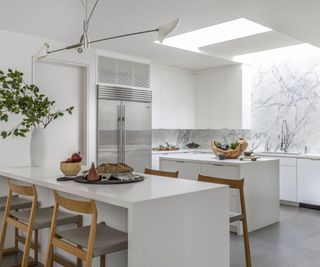 White kitchen, wooden chairs, skylight