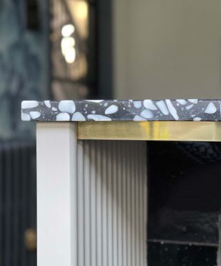 kitchen worktop with metallic edging and black and white terrazzo top
