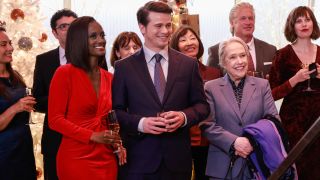 Skye P Marshall Jason Ritter and Kathy Bates stands together smiling at the Christmas party in Matlock S1 E7 - "Belly of the Beast."