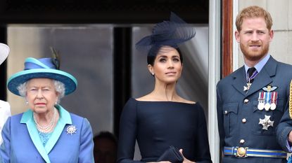 Queen Elizabeth II, Prince Harry, Duke of Sussex and Meghan, Duchess of Sussex on the balcony of Buckingham Palace as the Royal family attend events to mark the Centenary of the RAF on July 10, 2018 in London, England