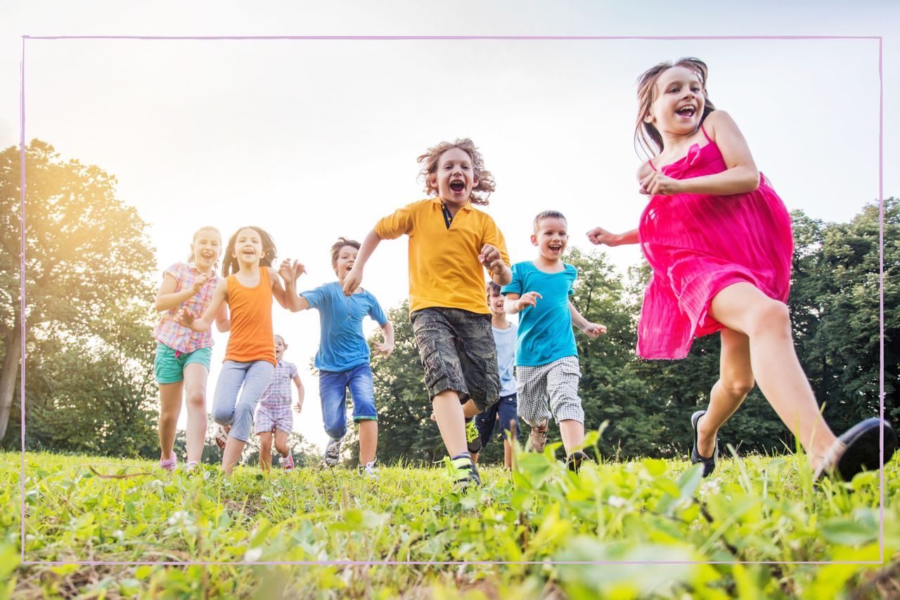 Children running through a field in summer