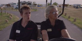 Frances McDormand and Linda May riding in a golf cart in Nomadland