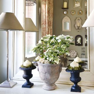 hallway with large mirror and console table and flowers and candles