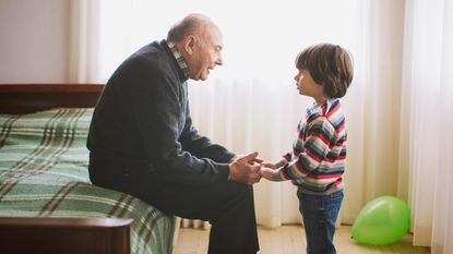 A grandfather has a heart-to-heart talk with his grandson.