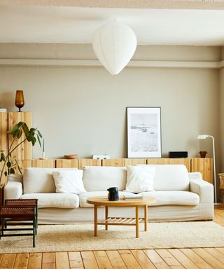 A white living room with a couch and table