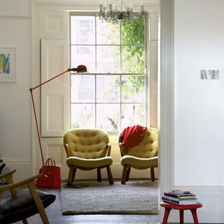 sitting room with white window and white walls