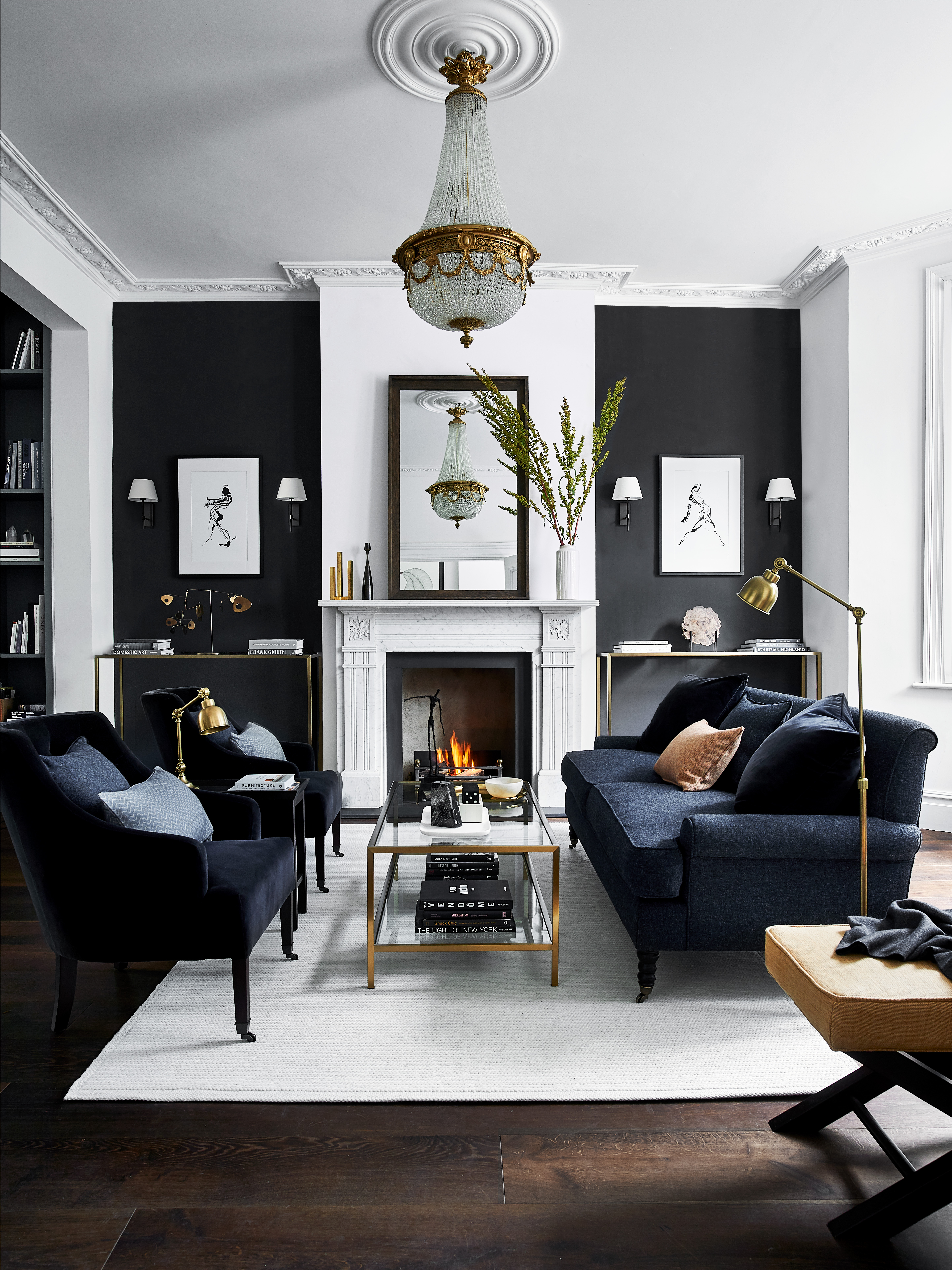A white living room with dark grey painted alcoves and blue velvet furniture designed by Neptune