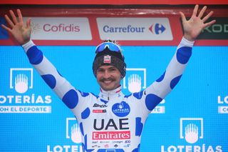 LAGOS DE COVADONGA SPAIN SEPTEMBER 03 Jay Vine of Australia and UAE Team Emirates celebrates at podium as Polka Dot Mountain Jersey winner during the La Vuelta 79th Tour of Spain 2024 Stage 16 a 1815km stage Luanco to Lagos de Covadonga 1069m UCIWT on September 03 2024 in Lagos de Covadonga Spain Photo by Tim de WaeleGetty Images