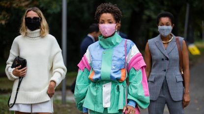 three women wearing face masks in the street, reusable face masks
