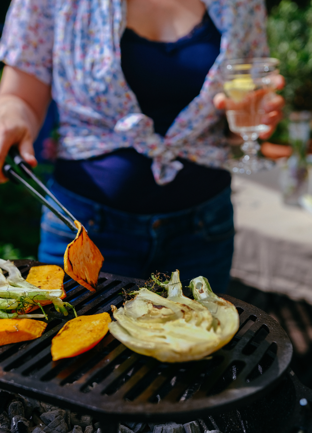 Woman tending to a BBQ