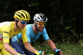 Mark Cavendish shares a conversation with race leader Tadej Pogačar during stage 5