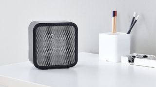 Amazon Basics Space Heater on a desk next to a pencil pot