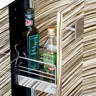 cabinet with bottles on pull out racks
