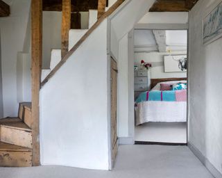 White bedroom with splashes of color in Grade II listed farmhouse in Sussex