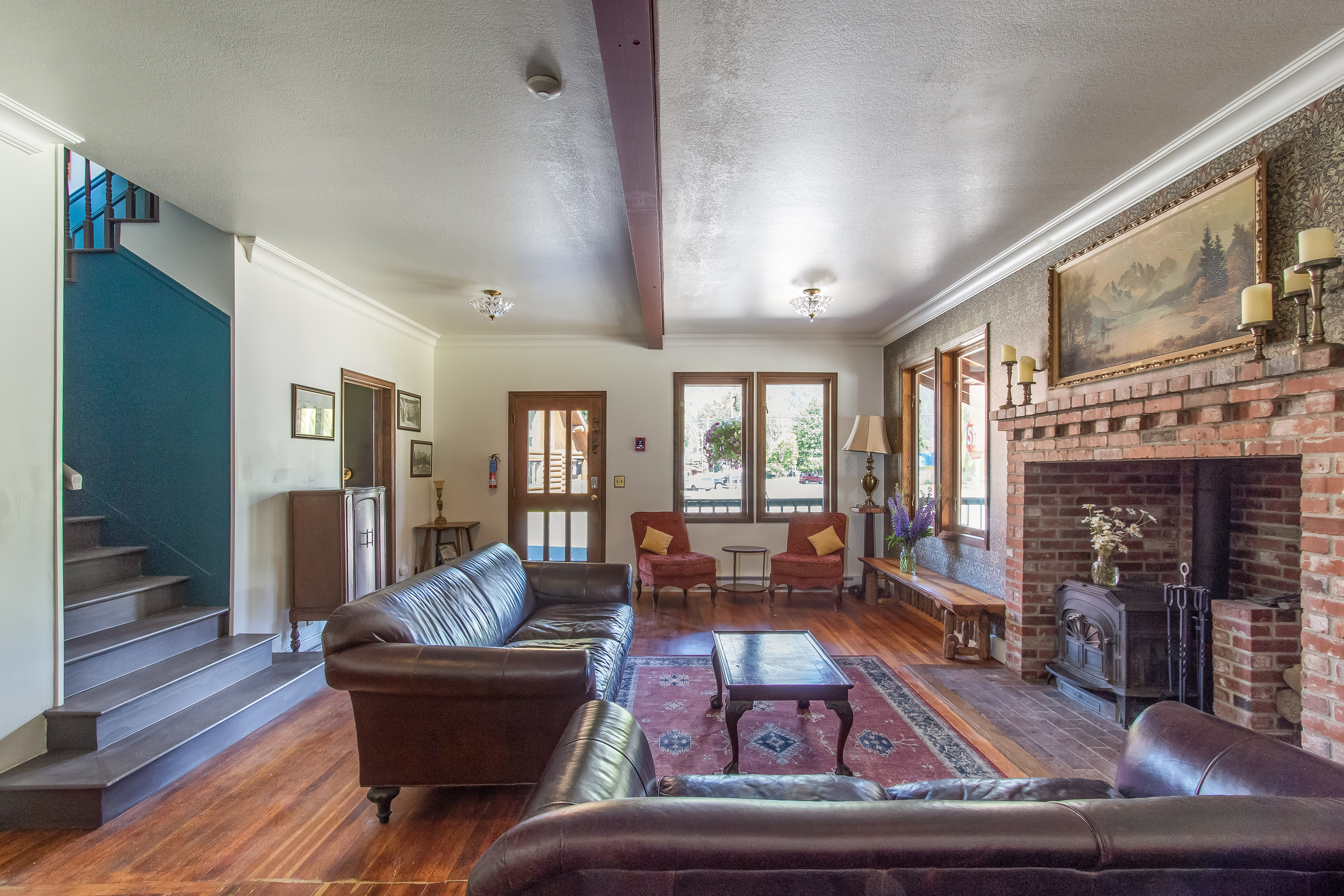 A couch in front of a fireplace at the Hotel Packwood's lobby parlor